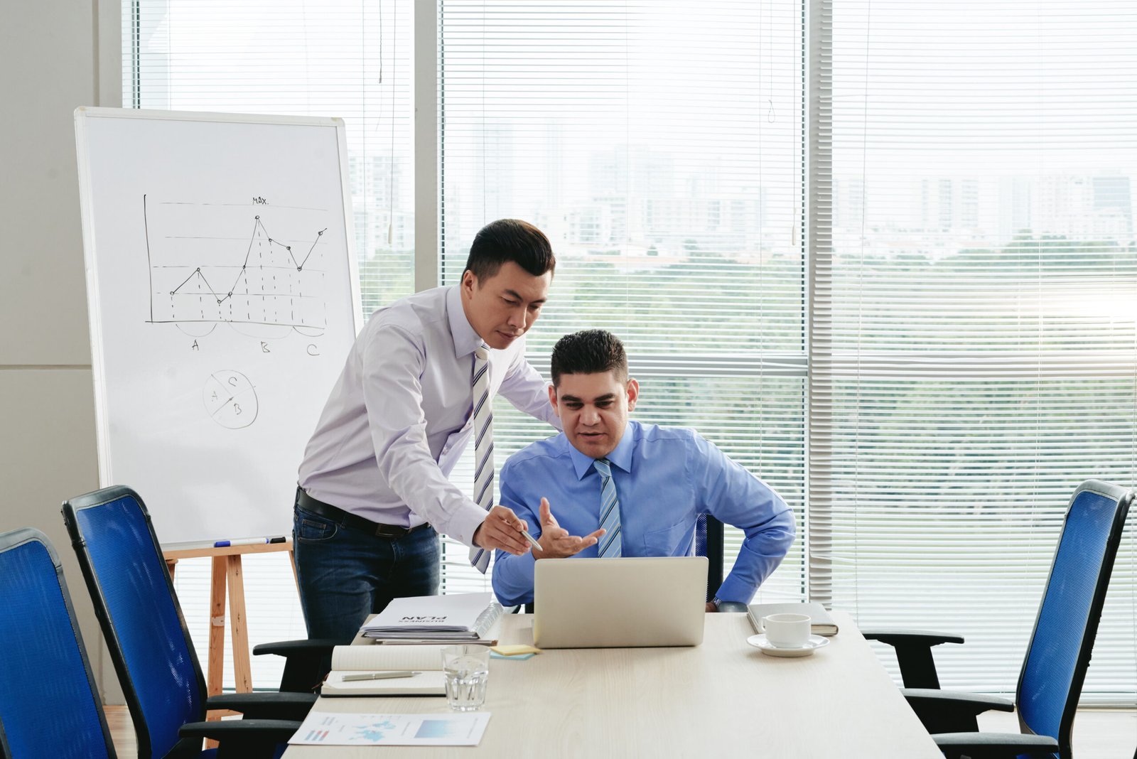 business associates looking through digital financial report scaled